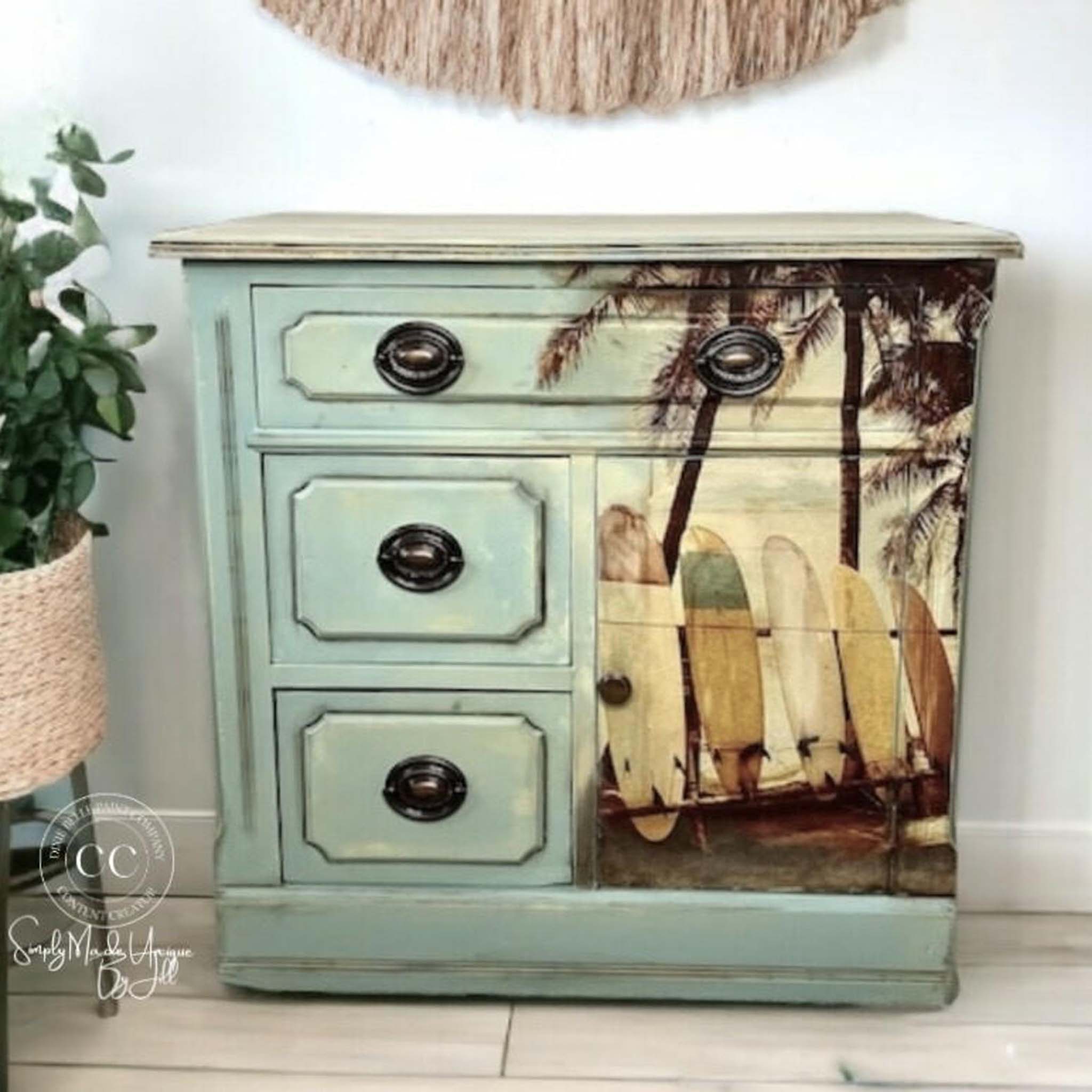 A small vintage dresser refurbished by Simply Made Unique by Jill is painted pale blue-green and features Belles and Whistles' Surf's Up A1 rice paper on the front.