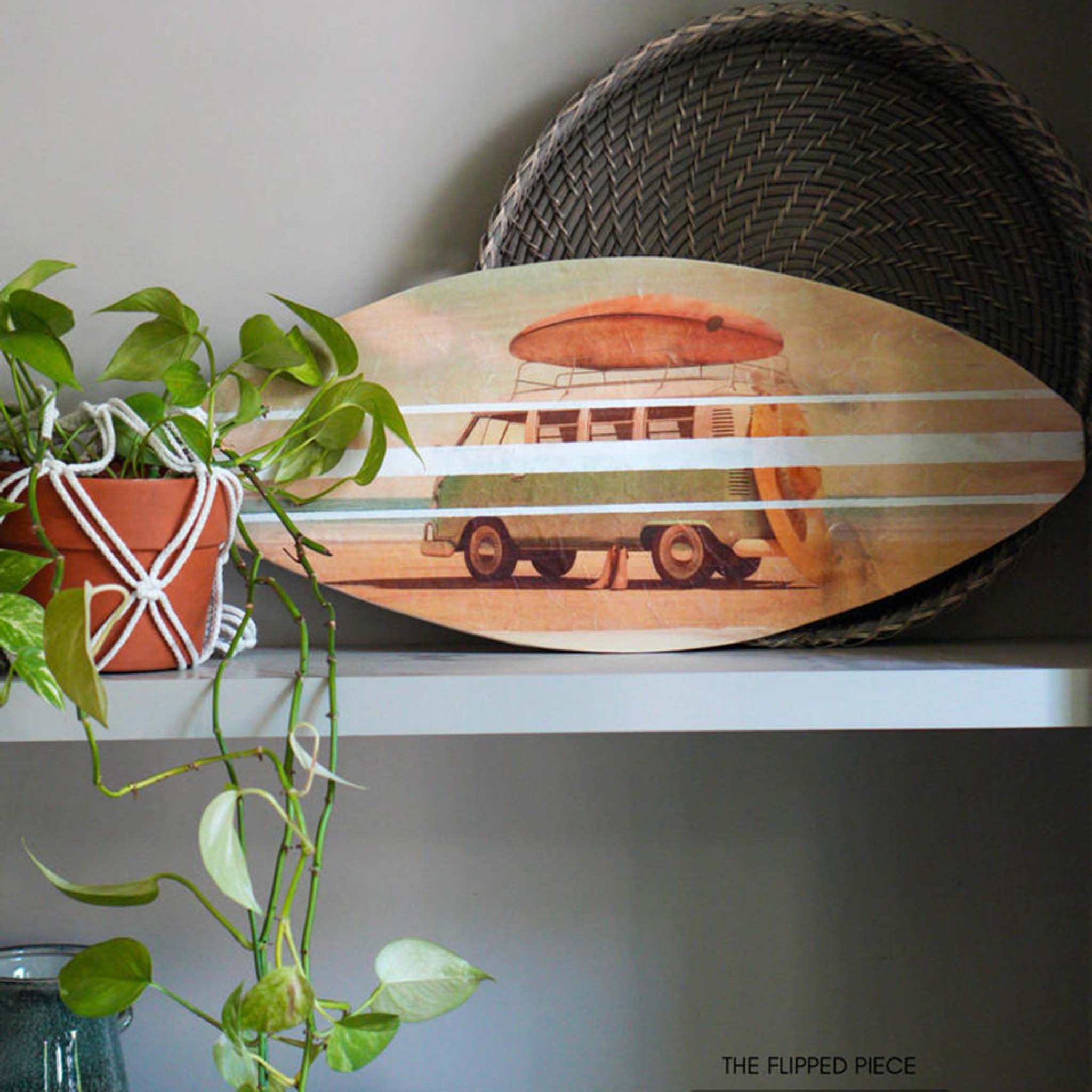 A small surf board shaped wood project is sitting on a self and features Belles and Whistles' Surf's Up A1 rice paper.
