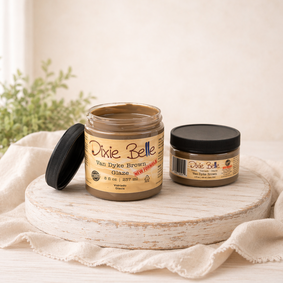 Two jars of Dixie Belle Van Dyke Brown Glaze on a wooden surface with a white background