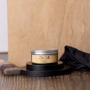 Jar of Dixie Belle wood finish on a wooden surface with a brush and cloth.