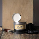 Metallic container of Dixie Belle Best Dang Wax on a wooden surface with a brush and black cloth.