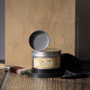 Metallic wax container with open lid on a wooden surface, featuring 'Dixie Belle' branding.