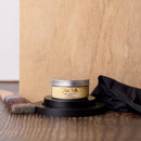 Jar of Dixie Belle wood finish on a wooden surface with a brush and cloth.