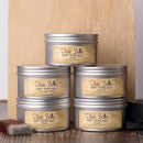 Stack of Dixie Belle Best Dang Wax tins on a wooden surface with a neutral background.