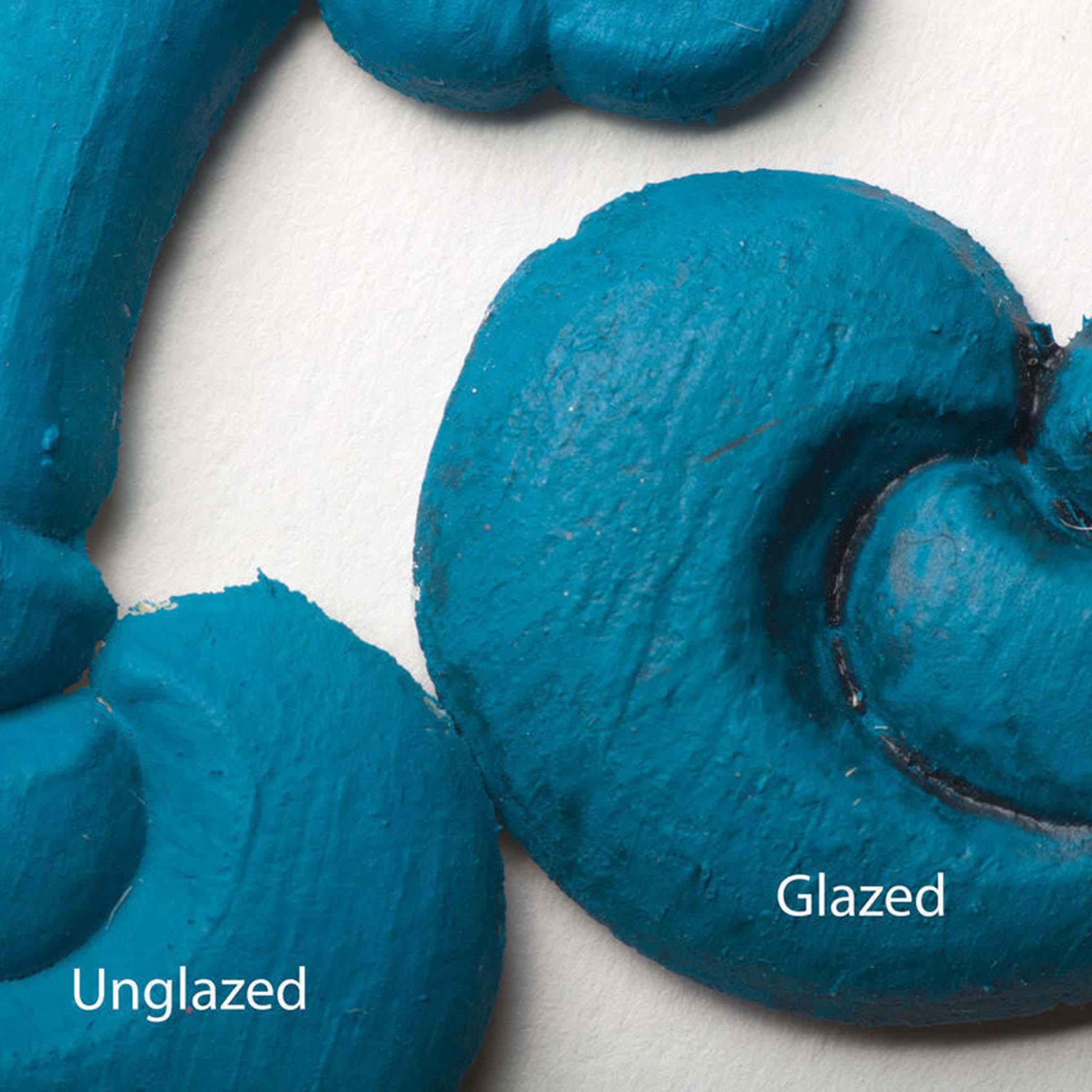 Close-up view of a teal blue colored silicone mould casting that shows the before and after use of Dixie Belle's Black Glaze.
