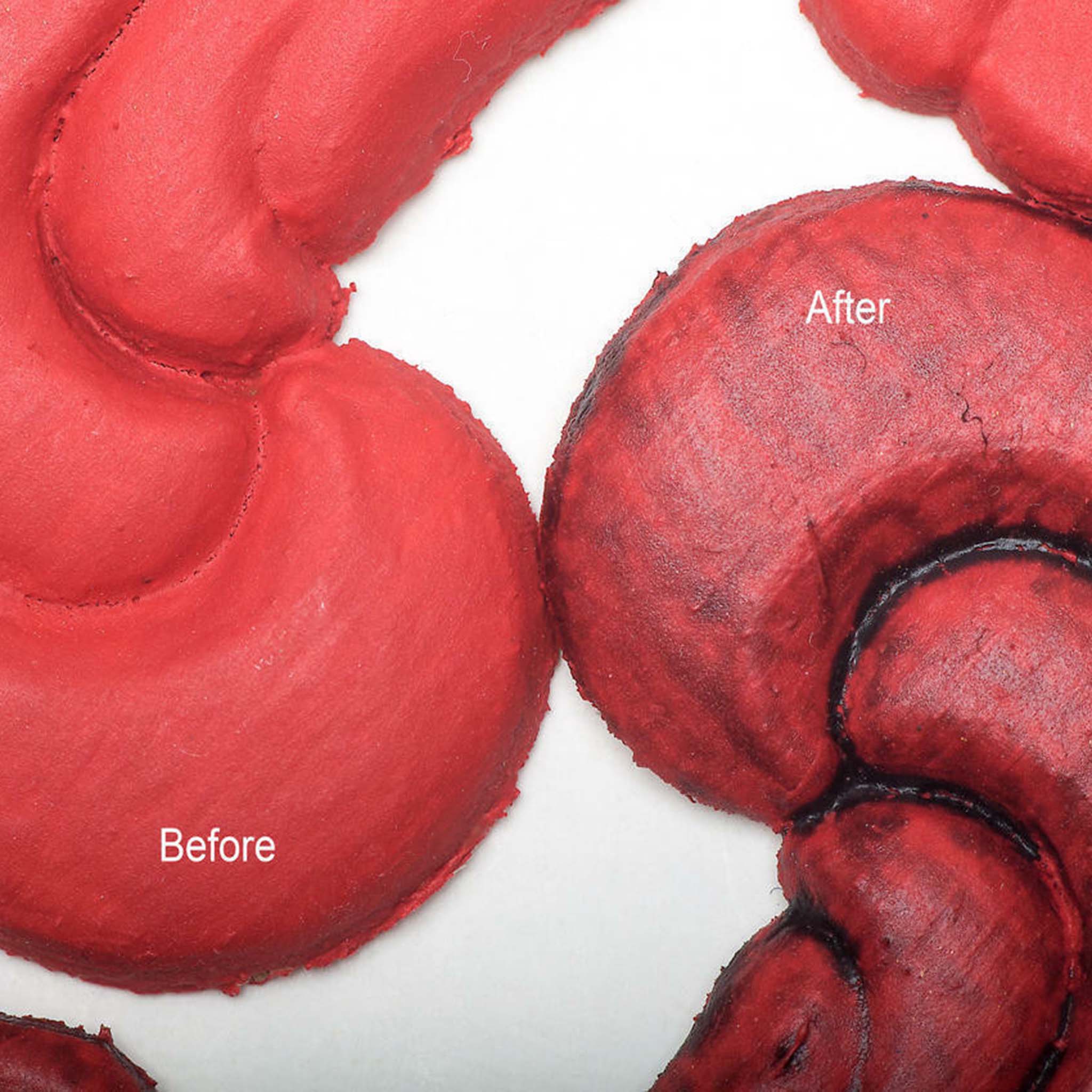 Close-up view of a coral colored silicone mould casting that shows the before and after use of Dixie Belle's Black Glaze.