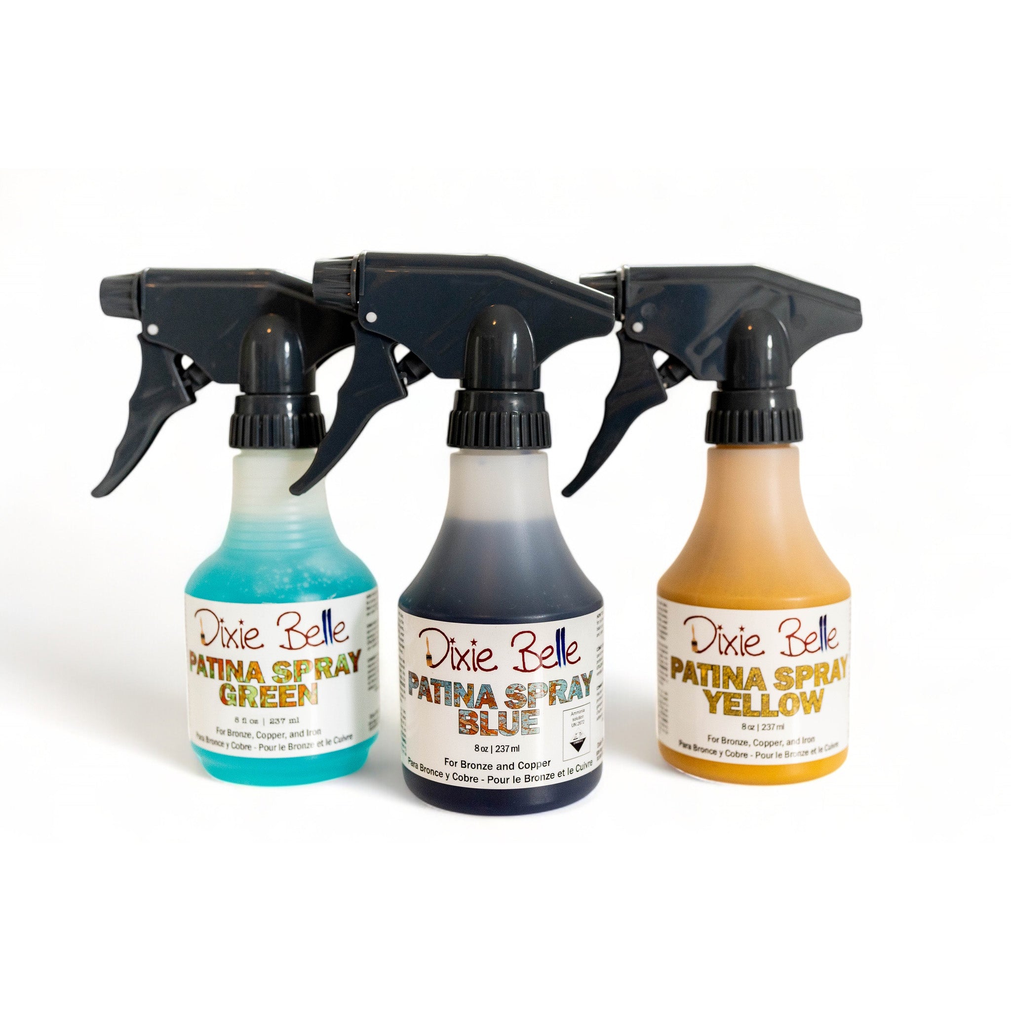 Three 8oz bottles of Dixie Belle Paint's Patina Spray in Green, Blue, and Yellow are against a white background.