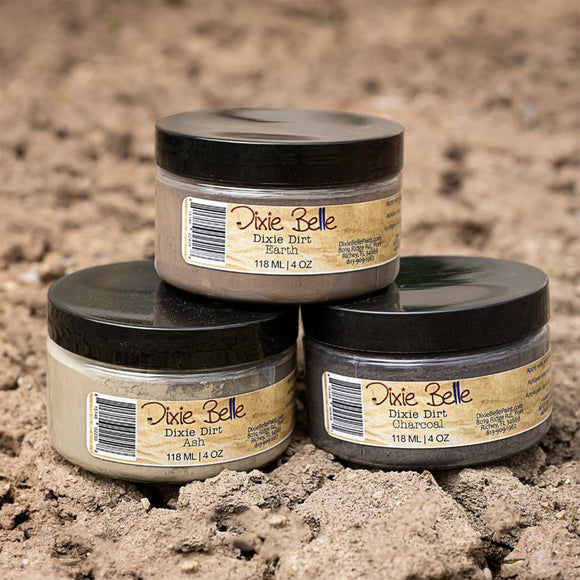 Three jars of Dixie Belle Dixie Dirt on a textured brown background
