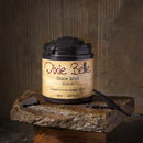 Jar of Dixie Belle Dixie Mud Black on a wooden block with a rustic background