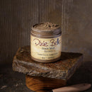 Jar of Dixie Belle Dixie Mud Brown on a stone surface with a rustic background