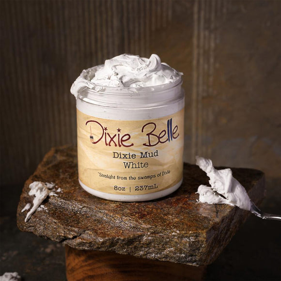 Jar of Dixie Belle Dixie Mud White on a stone surface with a rustic background