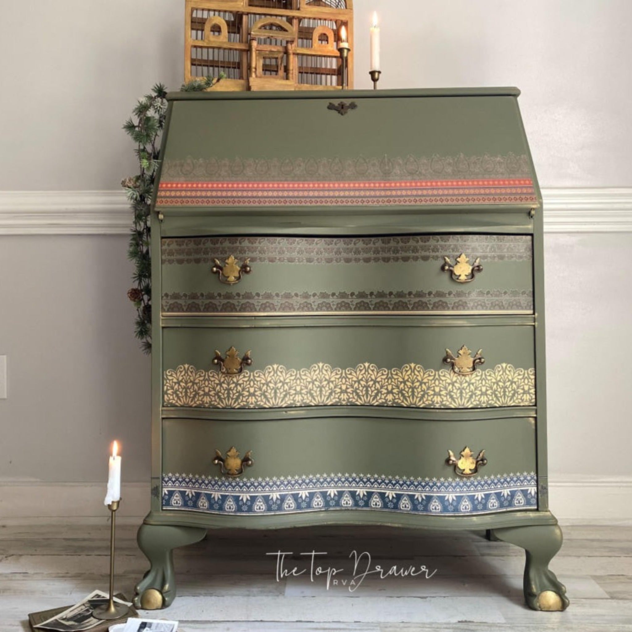 A vintage secretary's desk refurbished by The Top Drawer is painte sage green and features the Bohemian Dream transfer on it.