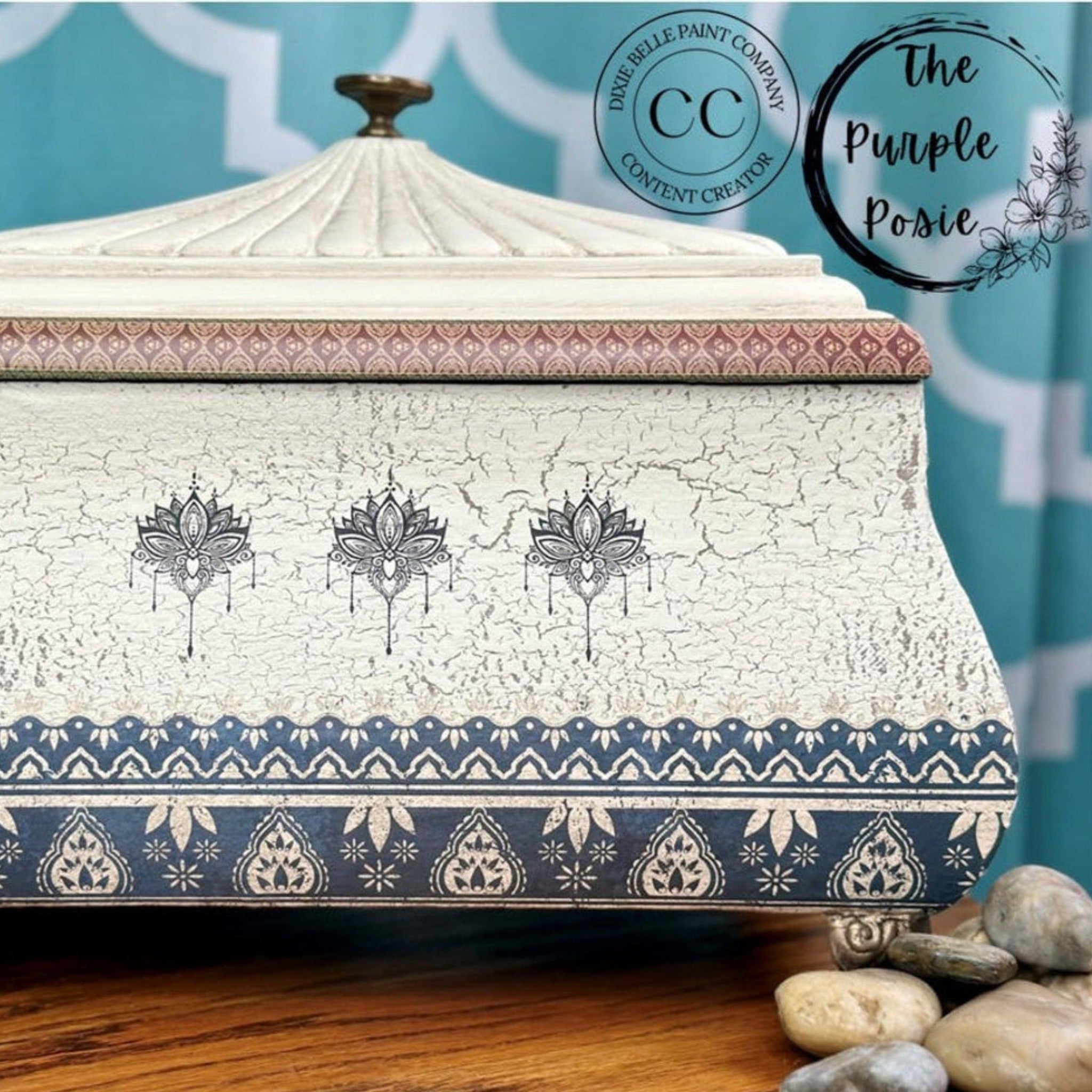 A small vintage table stop box refubished by The Purple Posie, A Dixie Belle Paint Co. Content Creator, is painted with a crackle white and features the Bohemian Dream transfer on it.