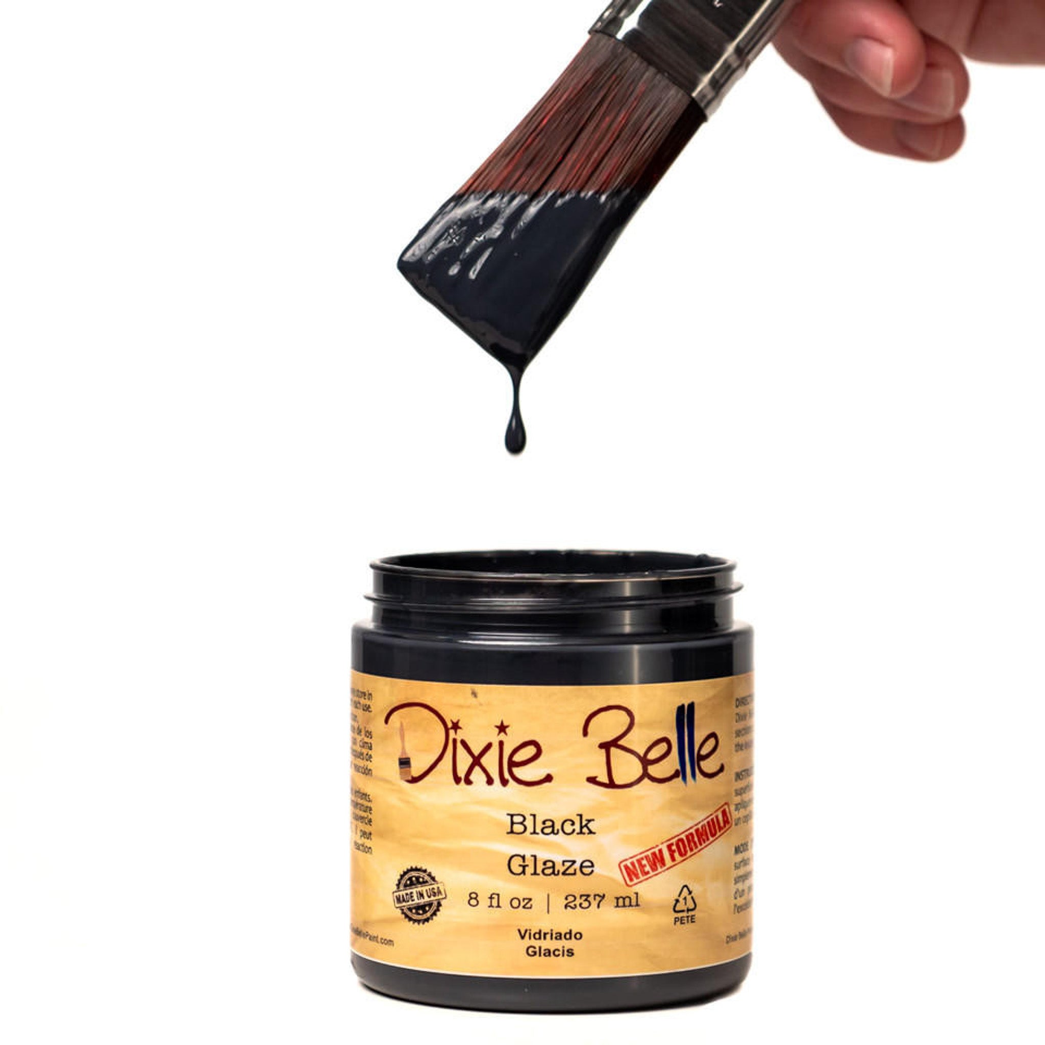 An open container of an 8oz/237ml Dixie Belle Black Glaze with a dripping paintbrush above it is against a white background.