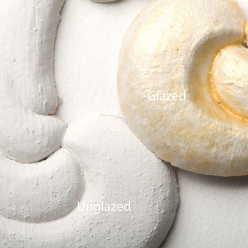 Close-up view of a white colored silicone mould casting that shows the before and after use of Dixie Belle's Gold Shimmer Glaze.