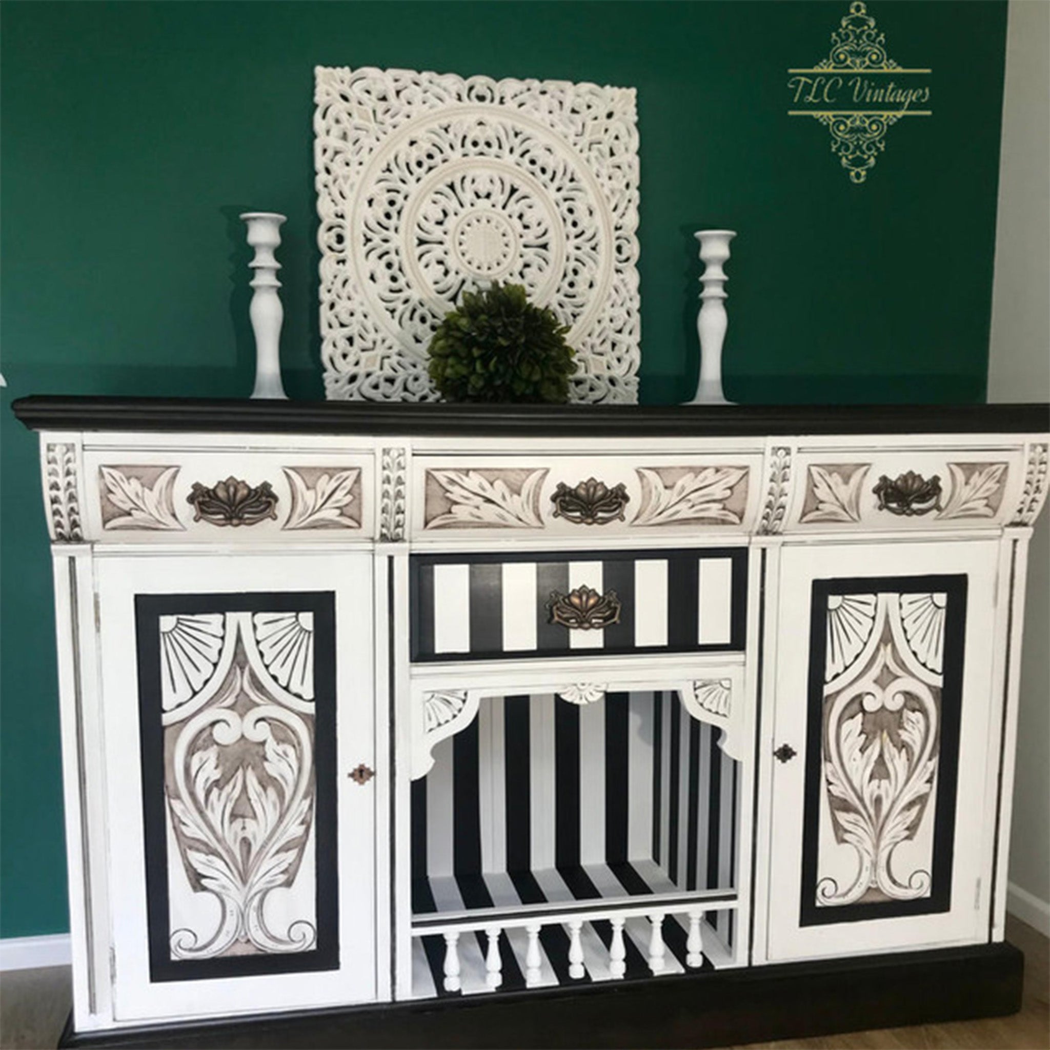 A large vintage buffet table refurbished by TLC Vintages is painted white and back and features details highlighted using Dixie Belle Paint's Grunge Glaze.