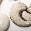 Close-up view of a white colored silicone mould casting that shows the before and after use of Dixie Belle's Grunge Glaze.