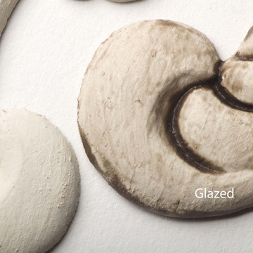 Close-up view of a white colored silicone mould casting that shows the before and after use of Dixie Belle's Grunge Glaze.