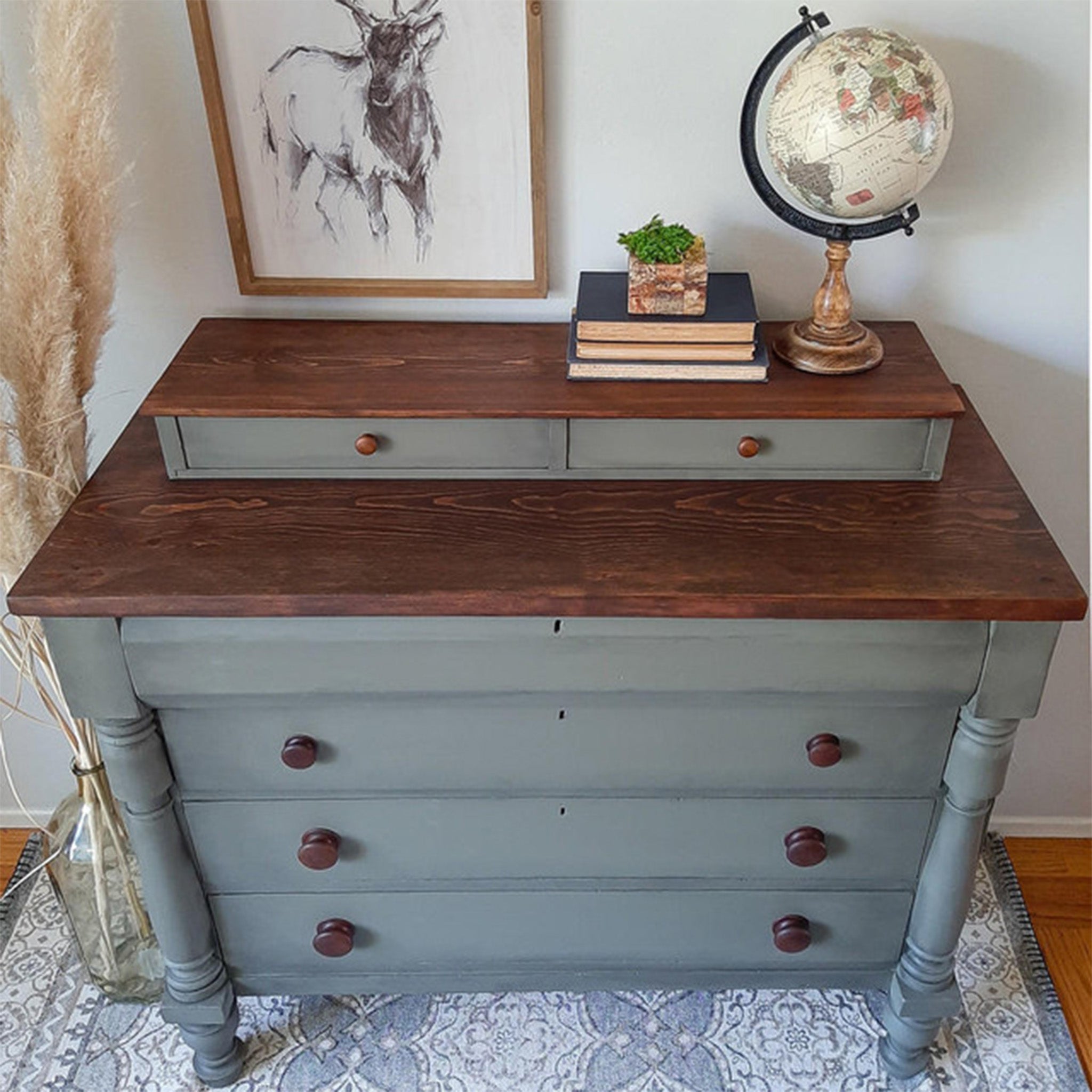 A vintage 4-drawer chest dresser with 2 smaller drawers on top is painted grey and features natural wood tops that are stained using Dixie Belle Paint's No Pain Gel Stain.