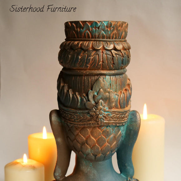 The backside of a statue head with ornate details refurbished by Sisterhood Furniture features Dixie Belle's Patina Paints on it.