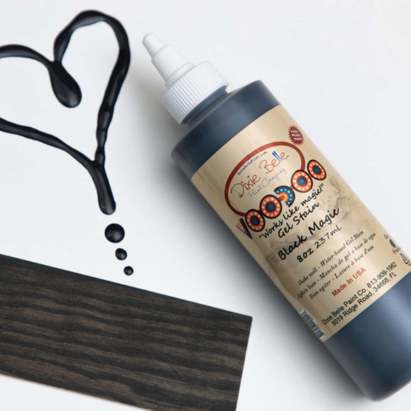 Dixie Belle's Black Magic Voodoo Gel Stain is against a white background with a wood stained swatch and a poured color sample.