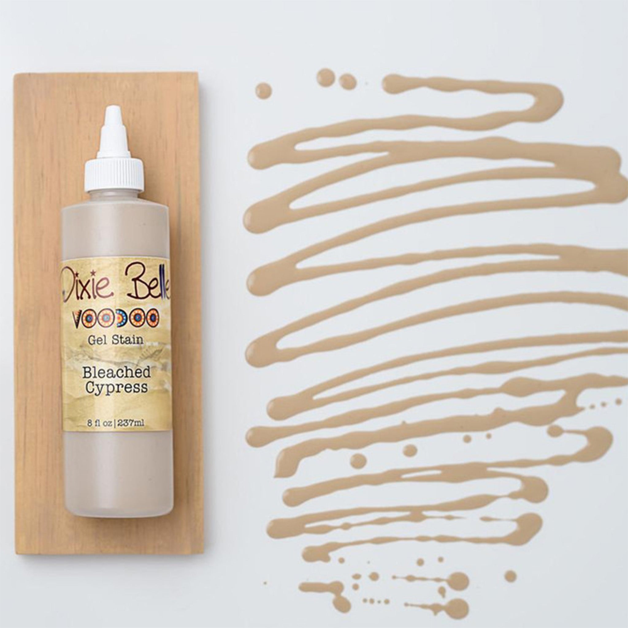 Dixie Belle's Bleached Cypress Voodoo Gel Stain is against a white background with a wood stained swatch and a poured color sample.