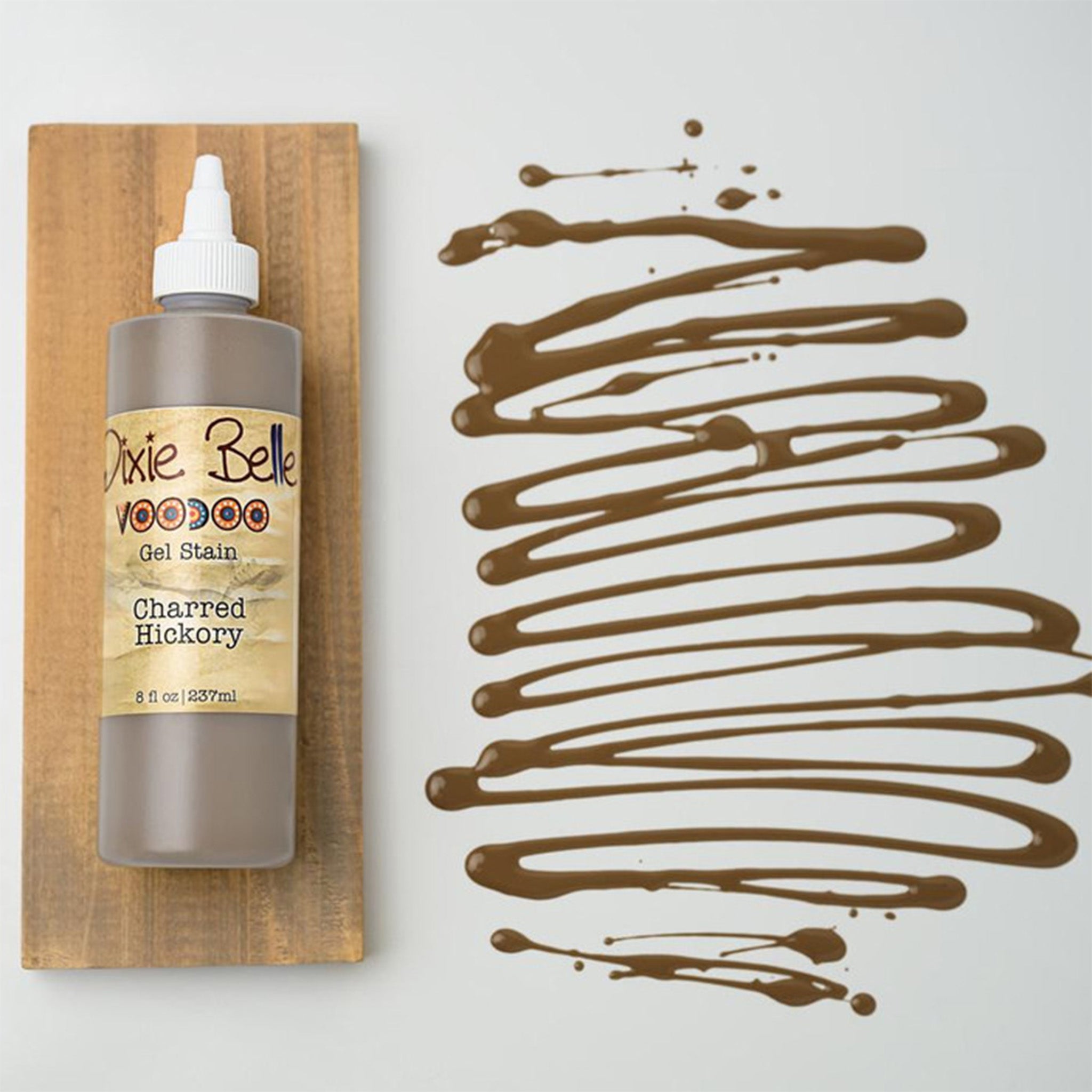 Dixie Belle's Charred Hickory Voodoo Gel Stain is against a white background with a wood stained swatch and a poured color sample.