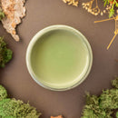 An arial view of an open container of Dixie Belle Paint Company’s Weeping Willow Chalk Mineral Paint is surrounded by green peat moss.