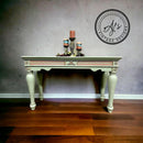 A vintage coffee table refurbished by Aj's Vintage Designs is painted in Dixie Belle's Weeping Willow chalk mineral paint.