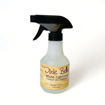 An 8 ounce spray bottle of Dixie Belle Paint's White Lightning Cleaner and Degreaser is against a white background.