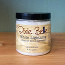 Jar of Dixie Belle White Lightning Cleaner and Degreaser on a wooden surface with a blue background
