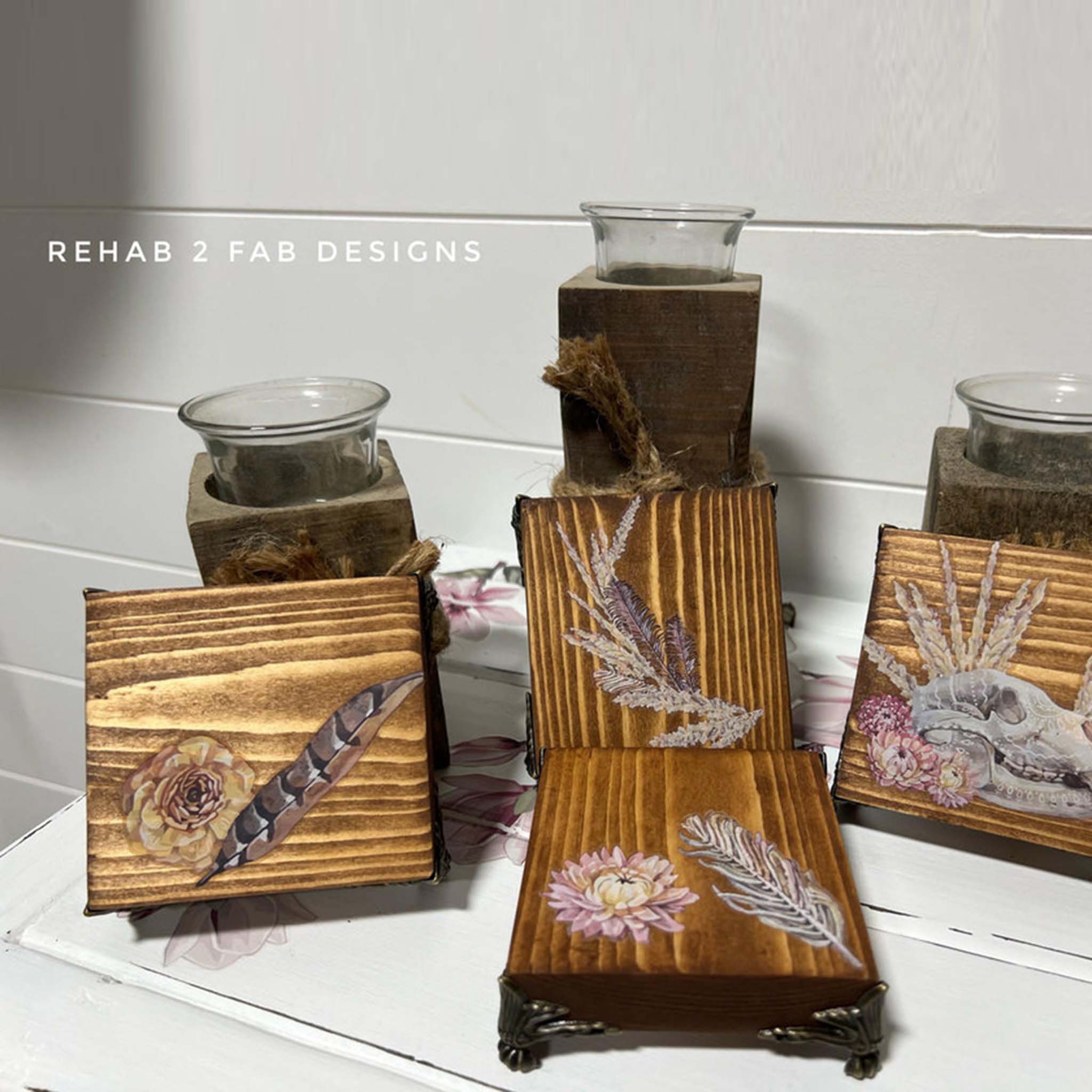 Four wood coasters created by Rehab 2 Fab Designs are stained a natural color and feature Belles & Whistles' Desert Moon small rub-on transfer on them.