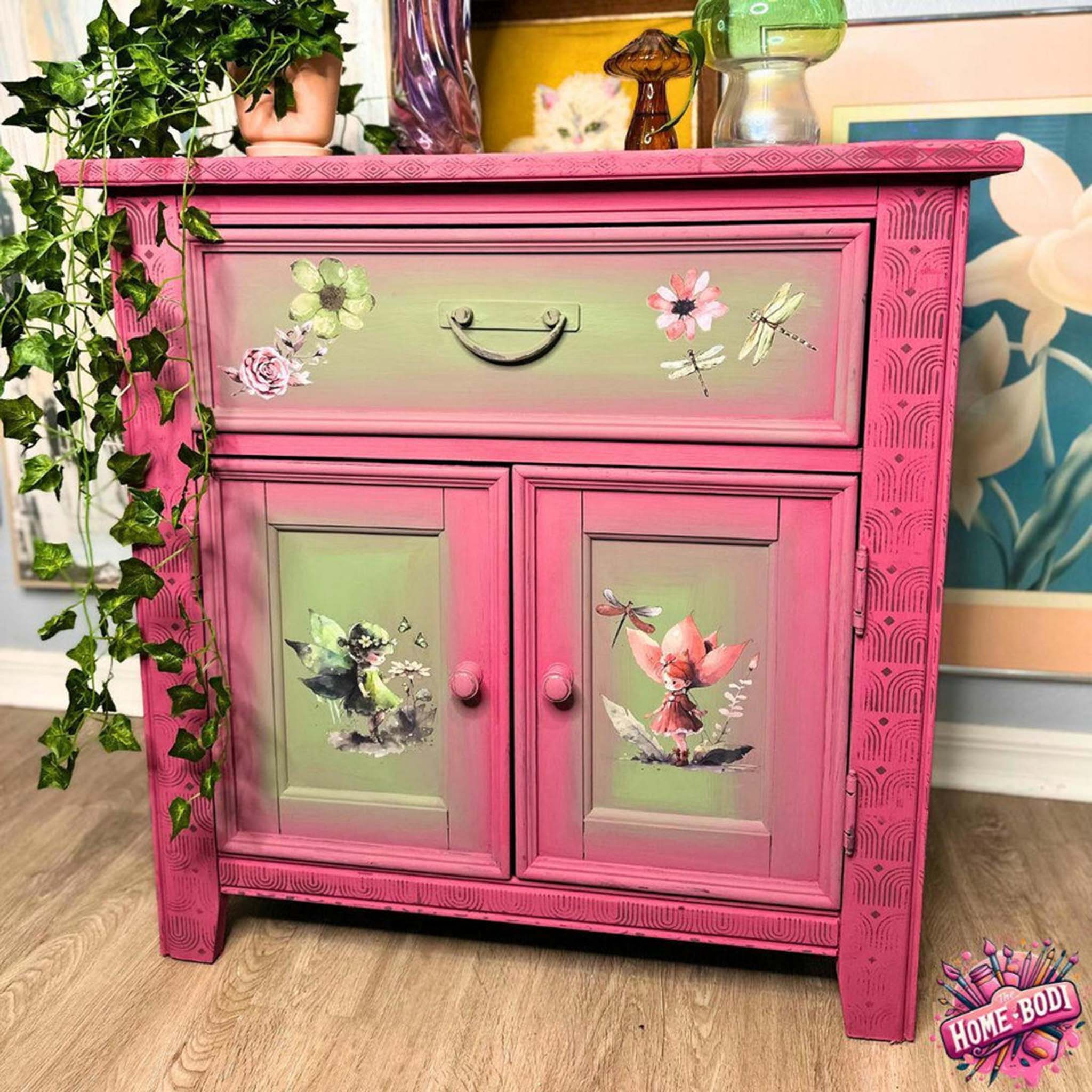 A vintage small buffet cabinet refurbished by The Home Bodi is painted pink and Spring green and features Belles & Whistles' Fairyland small rub-on transfer on its drawer and 2 doors.