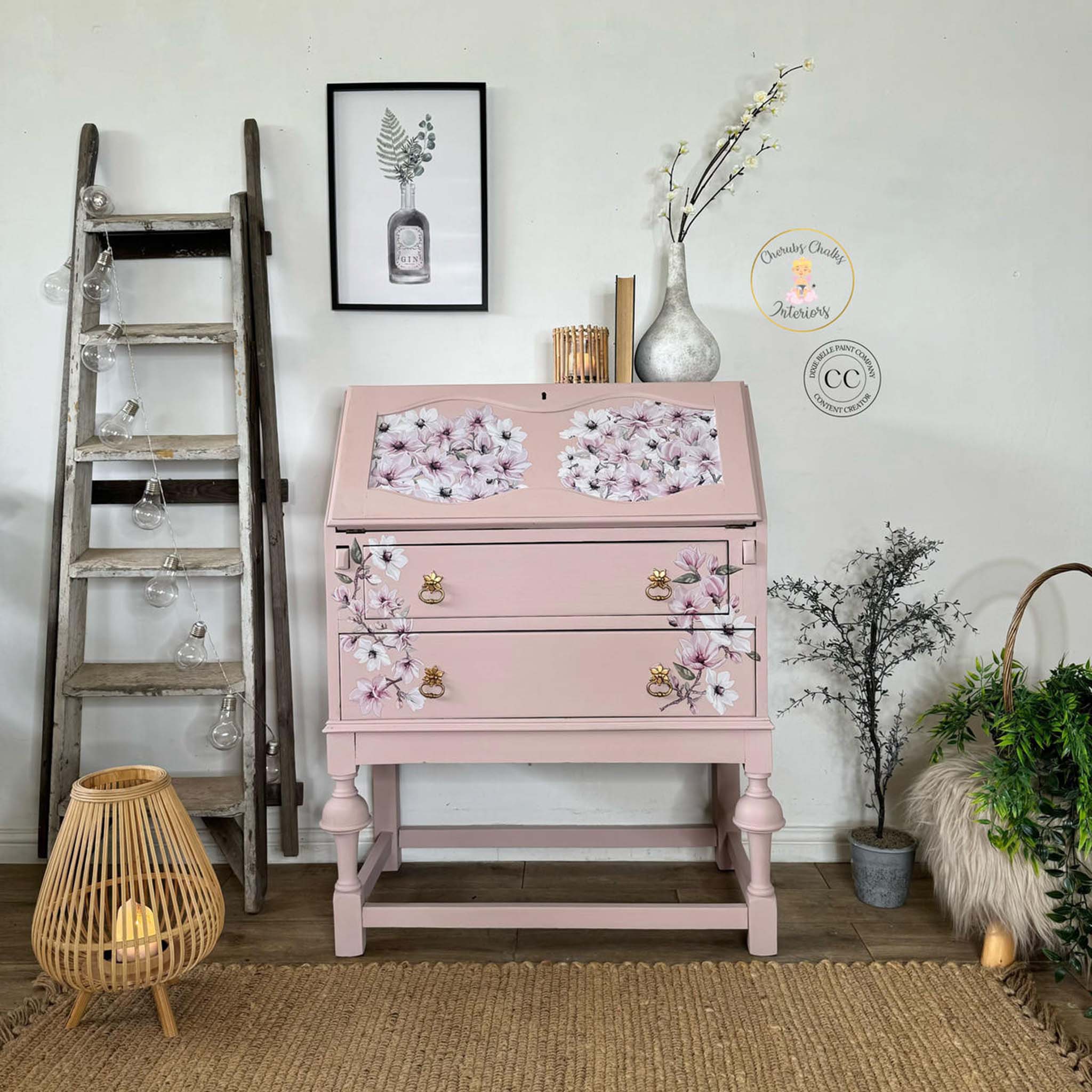A vintage secretary's desk refurbished by Cherub's Chalks Interiors is painted light pink and features Belles and Whistles' Magnificent Magnolia transfer on it.