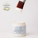 Jar of Silk all-in-one mineral paint with a brush dripping paint onto the lid, on a white background.