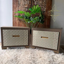 Two wooden dressers with patterned doors and gold handles on a textured surface.