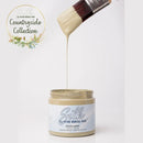 Silk All-in-One Mineral Paint being applied with a brush from a jar, on a white background with 'Countryside Collection' text.