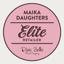 A white background with a pink circle with a brown outline and brown text reading: Maika Daughters. Elite Retailer. Dixie Belle Paint Company.