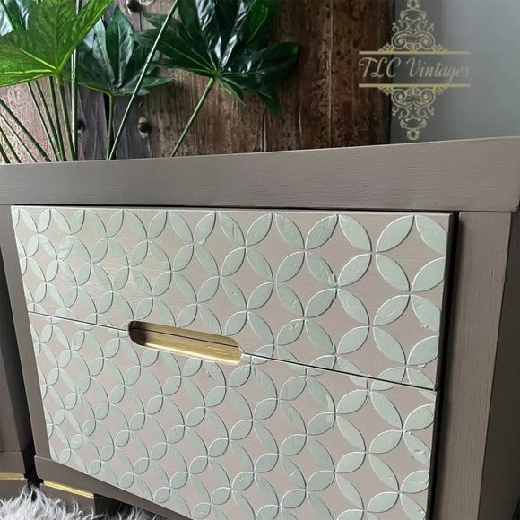 Wooden cabinet with decorative patterned doors and a gold handle, featuring the brand 'TLC Vintage' in the background.