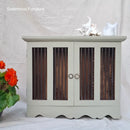Light gray cabinet with wooden panels and decorative items on a white background