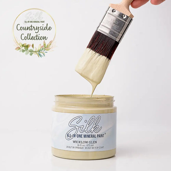 Silk All-in-One Mineral Paint being applied with a brush, featuring the Countryside Collection logo.