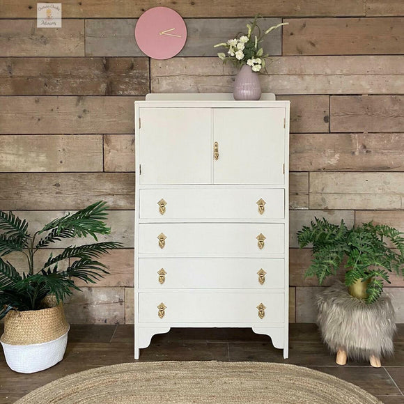 A vintage 4-drawer dresser armoire refurbished by Cherubs Chalks Interiors features Dixie Belle's Endless Shore Silk All-In-One Mineral Paint.