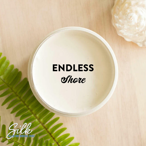 An arial view of an open container of Dixie Belle Paint Company's Endless Shore Silk All-In-One Mineral Paint is shown with black text reading Endless Shore.