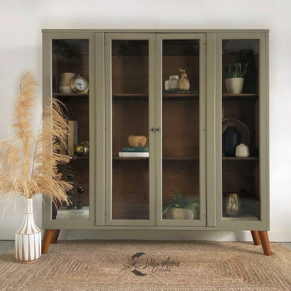A bookcase with 4 glass doors refurbished by Lilly Moon Vintage features Dixie Belle's Hampton Olive Silk All-In-One Mineral Paint.