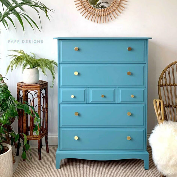 A large 7-drawer chest dresser refurbished by Faff Designs features Dixie Belle's Harbor Silk All-In-One Mineral Paint.