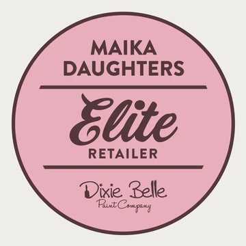A white background with a pink circle with a brown outline and brown text reading: Maika Daughters. Elite Retailer. Dixie Belle Paint Company.