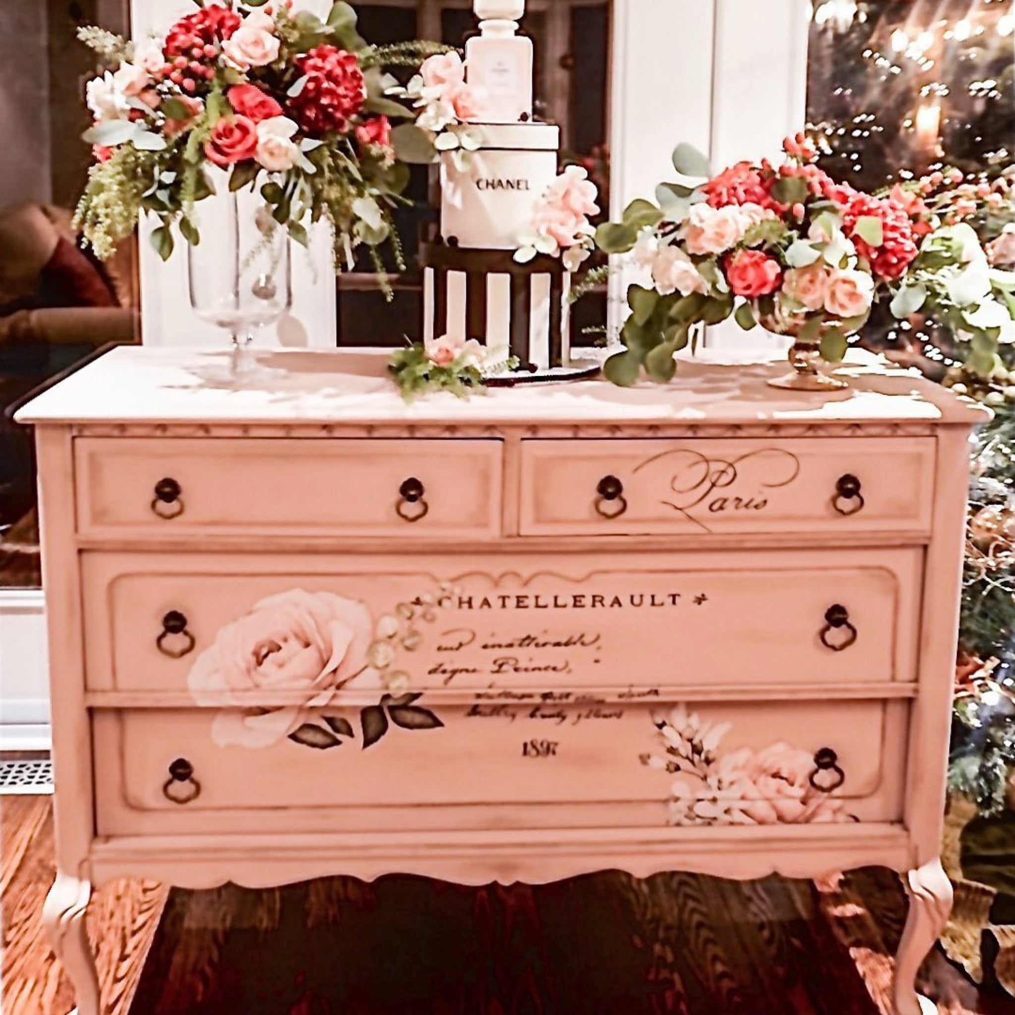 A vintage dresser is painted pink and features the Chatellerault transfer on its drawers.