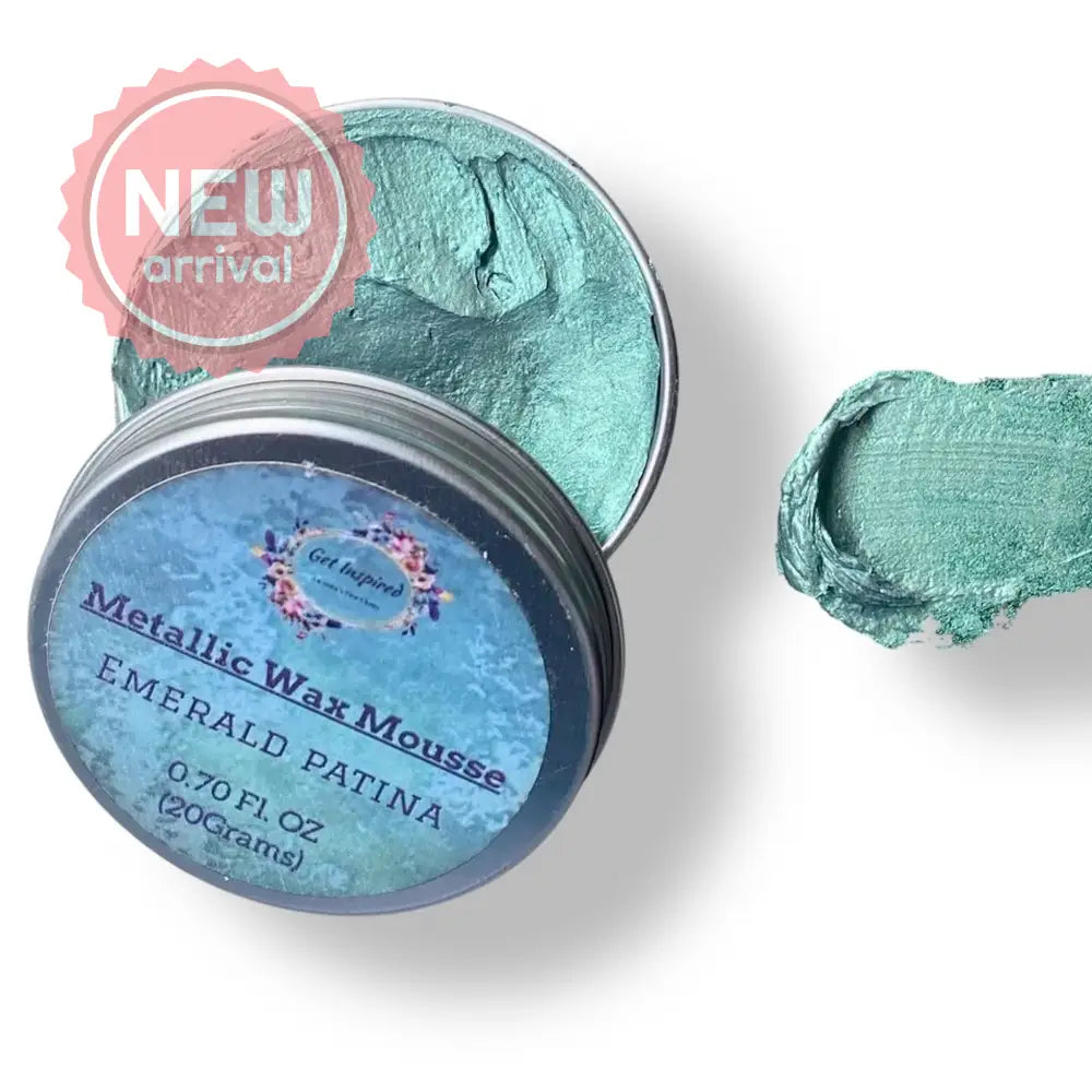 A 0.70 (20 ml) open container of a green patina color metallic wax mousse paste is against a white background.