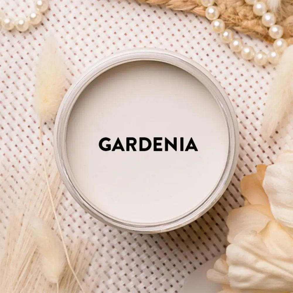 An arial view of an open container of Dixie Belle Paint Company's Gardenia Chalk Mineral Paint is shown with black text reading Gardenia.