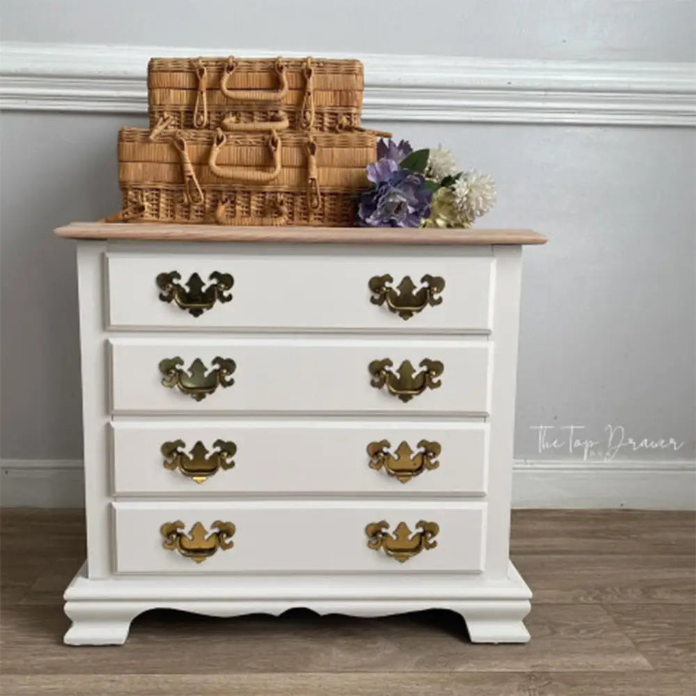 A vintage small 4-dawer chest dresser refurbished by The Top Drawer is painted in Dixie Belle's Gardenia Chalk Mineral Paint.